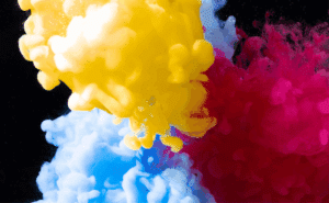 Bunte Farbwolken im Wasser als Symbol für Flow – der Moment, in dem Gedanken und Energie in Bewegung kommen.